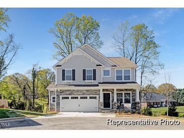 Charming two-story home featuring a stone facade, two-car garage, and a well-maintained front yard at 59 Curling Creek Dr # I285, Clayton, NC 27527