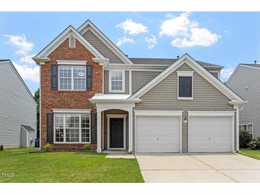 Charming two-story home featuring a combination of brick and siding facade with an attached two-car garage at 7414 Brandon Allen Ave, Raleigh, NC 27613