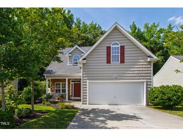 Charming home featuring a two-car garage, stone porch accents, and well-maintained landscaping at 8205 Rolling Glenn Dr, Raleigh, NC 27616