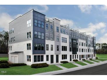 Modern townhome featuring a sleek design, multiple levels, and outdoor balconies in a residential community at 10537 Pleasant Branch Dr # 201, Raleigh, NC 27614
