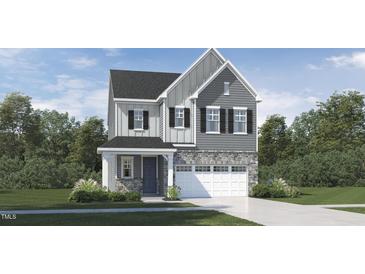 Charming two-story home with stone accents, a covered entryway, and a two-car garage at 1244 Coral Cay Bnd, Wake Forest, NC 27587