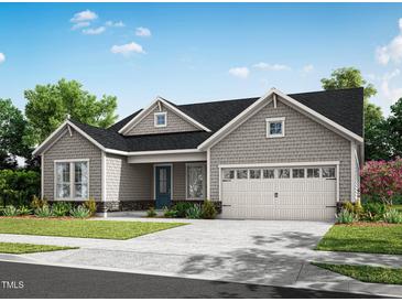 Charming one-story home with gray shingle siding, gabled roof, and a two-car garage at 36 Firefly Ln, Fuquay Varina, NC 27526