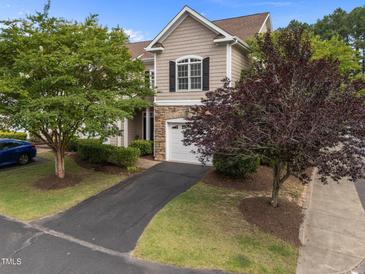 Charming townhome featuring a stone facade, attached garage, and well-maintained landscaping at 5515 South Roxboro # 32, Durham, NC 27713