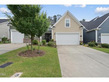Charming single-Gathering home featuring a well-maintained lawn and attached two-car garage at 605 Smallwood Dr, Durham, NC 27703