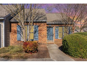 Charming brick townhome with well-maintained landscaping and blue shutters at 61 Fashion Pl, Durham, NC 27705