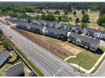 New townhome community featuring modern exteriors, landscaping, and a nearby golf course for added recreational opportunities at 749 Parc Townes Dr # 33, Wendell, NC 27591