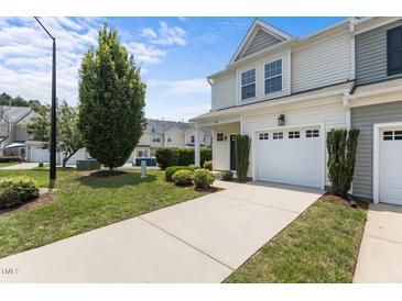 Charming townhome with an attached one car garage and a manicured front lawn at 948 Consortium Dr, Raleigh, NC 27603
