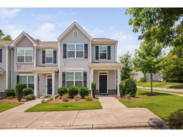 Charming townhome with manicured lawn and traditional architectural details at 102 Harvest Oaks Lane # 38, Durham, NC 27703