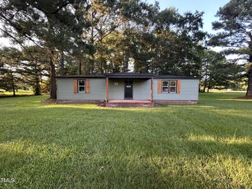 Charming single story home with green siding, wood shutters, and a well-manicured lawn at 10248 Nc-43, Rocky Mount, NC 27801