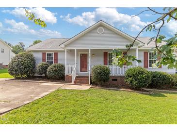 Charming single-story home featuring a well-manicured lawn and a cozy front porch with red shutters at 1113 Curtiss Dr, Garner, NC 27529