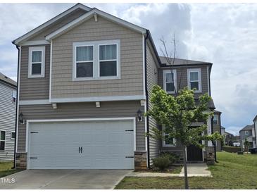 Charming two-story home with a two-car garage and landscaped front yard at 112 Wilbur Lake Dr, Fuquay Varina, NC 27526