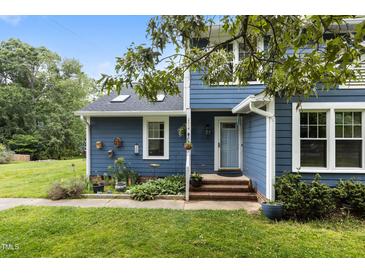 Charming blue two-story home featuring a landscaped front yard and a cozy entryway at 2214 Pathway Dr, Chapel Hill, NC 27516