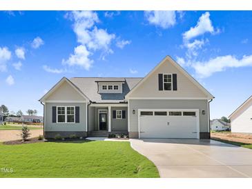 Charming single-Gathering home with a well-manicured lawn and inviting curb appeal, complete with attached garage at 222 Cherrybirch Ln, Zebulon, NC 27597
