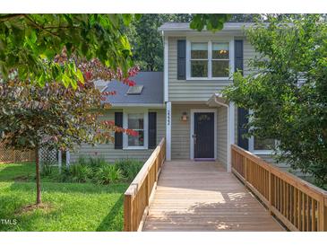 Charming home featuring a wooden walkway leading to the front door and dormer windows at 2222 Pathway Dr, Chapel Hill, NC 27516