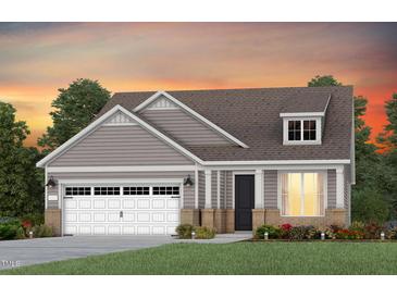 Charming single-story home featuring a two-car garage, dormer window and welcoming front porch at 273 Arcadius Dr, Clayton, NC 27520