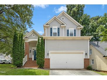 Charming two-story home with gray siding, brick accents, and a well-manicured front yard at 5301 Denmead Way, Raleigh, NC 27613
