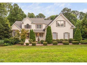 Charming two-story home with landscaped yard, painted brick, mature trees, and inviting curb appeal at 602 Preston Village Way, Cary, NC 27519