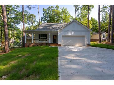 Charming single-Gathering home with a covered porch and well-maintained front yard at 6069 Jones Cir, Sanford, NC 27332