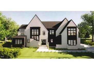 Charming two-story home with a striking modern design, multiple windows, and fresh landscaping at 6908 Bent Pine Pl, Raleigh, NC 27615