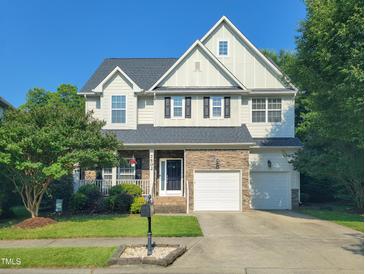 Charming two-story home features a well-manicured lawn, stone accents and a two-car garage at 7502 Hedfield Way, Durham, NC 27713