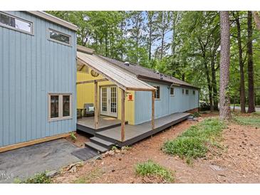 Charming home exterior featuring a porch and natural surroundings at 908 Cedar Fork Trl, Chapel Hill, NC 27514