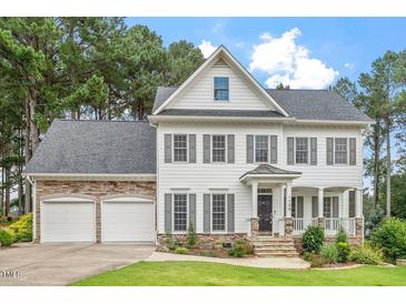 Charming two-story home with a manicured lawn and a two-car garage at 1120 Colonial Club Rd, Wake Forest, NC 27587