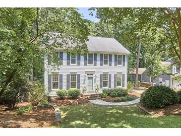 Charming two-story home with gray shutters, landscaped yard, and mature trees at 18 Clearwater Dr, Durham, NC 27707