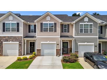 Charming townhome with a one car garage, covered entry and landscaped front yard at 1891 Frost Dr, Haw River, NC 27258