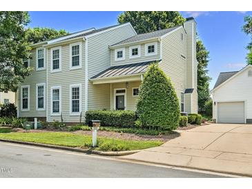 Charming two-story home featuring a well-manicured front yard, attached garage, and classic architectural details at 2000 Silky Dogwood Trail Trl, Apex, NC 27502