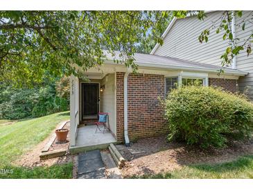 Charming brick home featuring a cozy, covered front entrance and landscaped yard at 2213 Alpine Rd, Durham, NC 27707