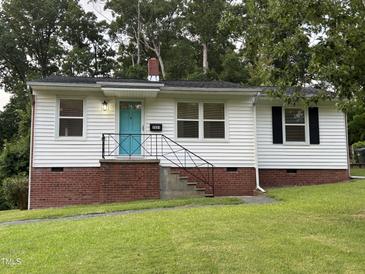 Charming single-story home with brick foundation, a blue door, and a well-maintained lawn at 2331 Kennington Rd, Raleigh, NC 27610