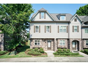Charming two-story townhome featuring stone accents, neutral siding, and well-maintained landscaping at 2808 Carter Finley Pl, Raleigh, NC 27606