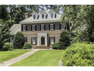 Stately brick home with dormer windows, black shutters, and a well-manicured lawn at 3112 Lake Pointe Trl, Rocky Mount, NC 27804