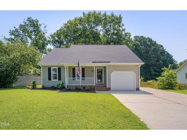 Charming home with a well-manicured lawn, inviting porch, and attached single-car garage at 4140 Willow Haven Ct, Raleigh, NC 27616