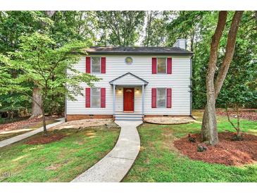 Charming two-story home featuring red shutters, a bright red door, and a landscaped front yard with a concrete walkway at 508 Bolin Creek Dr, Carrboro, NC 27510