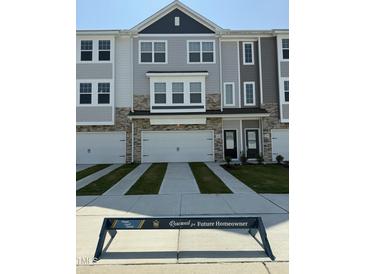 Charming townhome with attached garages, stone accents, and modern design in a friendly community at 5324 River Reach Dr, Raleigh, NC 27616