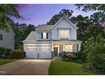 Charming two-story home features a two car garage, manicured lawn and inviting front porch at 108 Market Cross Ct, Holly Springs, NC 27540