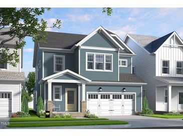 Charming two-story home with blue siding, white trim, an attached garage, and lovely landscaping at 154 Beacon Dr, Pittsboro, NC 27312
