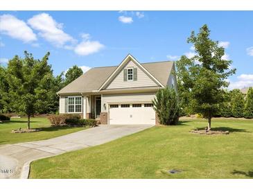 Charming single-story home with a well-manicured lawn, attached garage, and inviting curb appeal at 1705 Bodwin Ln, Apex, NC 27502