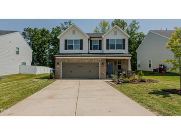 Charming two-story home with a well-maintained lawn and a two-car garage at 2586 Lacey Holt Rd, Graham, NC 27253
