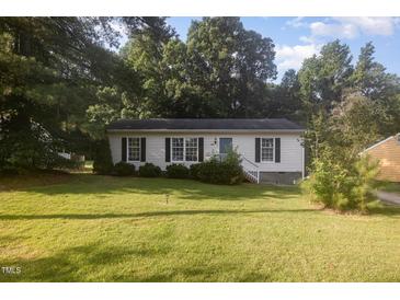 Charming single-story home features a well-maintained lawn and cozy curb appeal surrounded by mature trees at 308 Plaza Dr, Garner, NC 27529