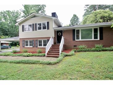Charming brick and siding two-story home with inviting front steps and a well-maintained yard at 3812 Vesta Dr, Raleigh, NC 27603