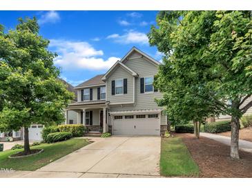Two-story home with a two-car garage, a well-manicured lawn, and mature trees at 428 Mill Station Ln, Wendell, NC 27591