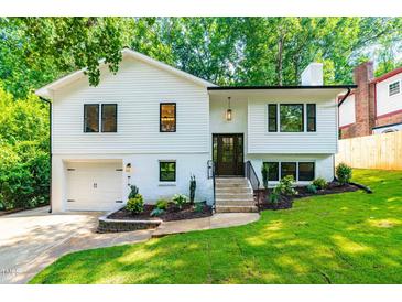 Charming two-story home features a freshly painted exterior, manicured landscaping, and an attached garage at 4349 Pickwick Dr, Raleigh, NC 27613
