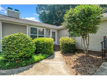 Charming single-story home with a well-manicured lawn and a welcoming front entrance at 6016 Farm Gate Rd, Raleigh, NC 27606