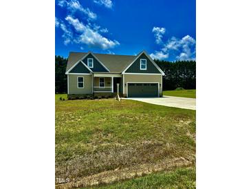 Charming one-story home featuring a two-car garage and a covered front porch at 106 Viola Ln, Franklinton, NC 27525