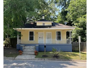 Charming yellow home with a cozy front porch and well-maintained landscaping at 1108 Taylor Street, Durham, NC 27701
