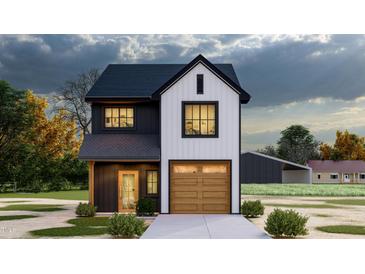 Modern farmhouse with contrasting black and white exterior, accented by a wood garage door at 17 Runneymede Pl, Smithfield, NC 27577