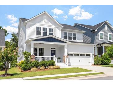 Charming two-story home boasts a manicured lawn and attached garage with a traditional architectural style at 223 Chauncey Cir, Chapel Hill, NC 27516