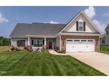 Charming two-story home with a manicured lawn and inviting curb appeal at 2413 Whelen Dr, Graham, NC 27253